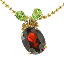 14k yellow gold beaded chain with oval garnet and two pear shaped peridot